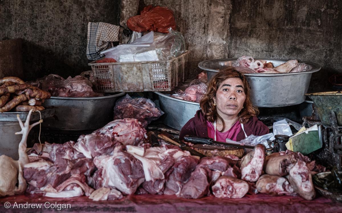 Balinese Market Butcher by Andrew Colgan